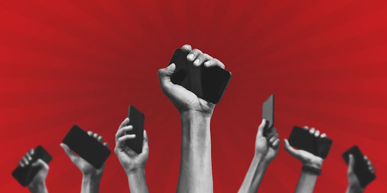 group of people's hands holding phones up in front of a red background