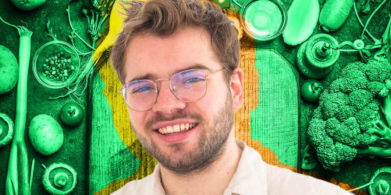 man over vegetables and cutting board background