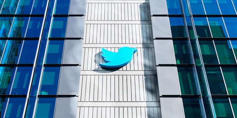 Twitter logo sign on tall building with large windows