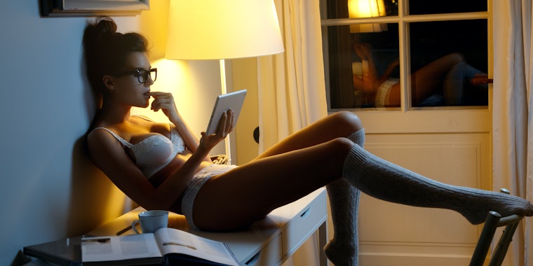 best-selling sex toys on amazon featured image - a woman reclining on her desk buying something on her tablet in her underwear