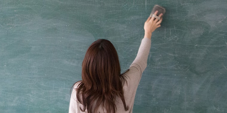 woman erasing blackboard