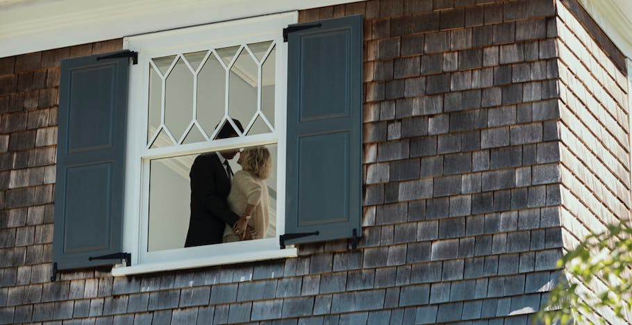 A couple being watched through a window