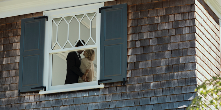 A couple being watched through a window