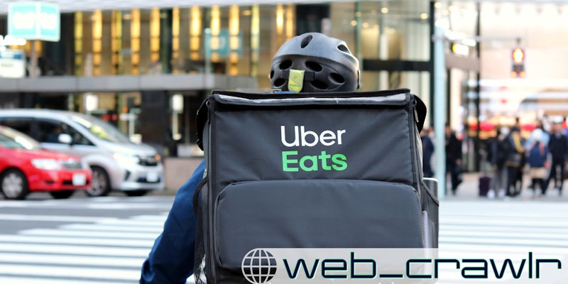 An Uber Eats delivery worker. The Daily Dot newsletter web_crawlr logo is in the bottom left corner.