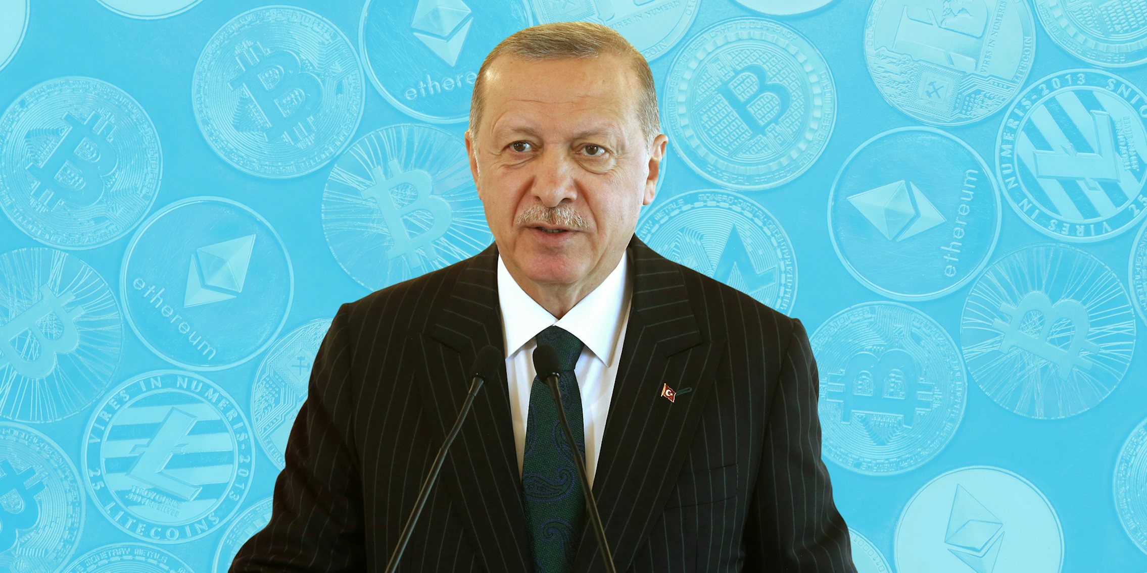 Recep Tayyip Erdogan speaking into microphone in front of blue crypto background