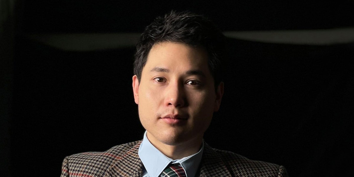 Andy Ngo in front of dark background