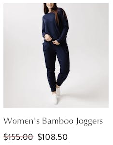 A screenshot of the Cozy Earth website showing a woman in a navy blue bamboo jogging leisure suit marked down from $155 to $108.50.