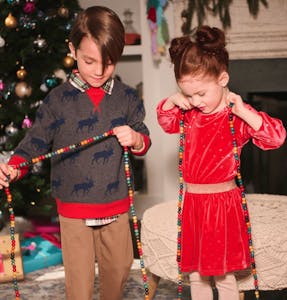 Two children in Hatley holiday outfits.