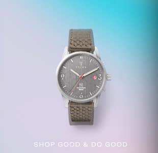 best cyber monday clothing deals - A charcoal Triwa watch against an aqua and lavender gradient background with the words "shop good & do good" beneath in white letters.