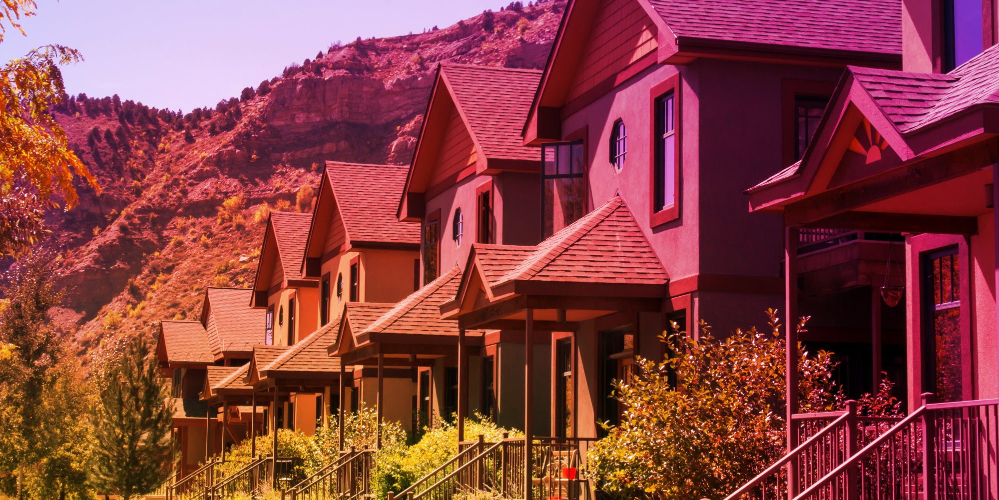 houses with Colorado mountains behind with Instagram gradient overlay