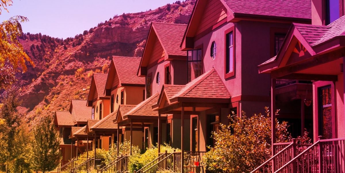 houses with Colorado mountains behind with Instagram gradient overlay