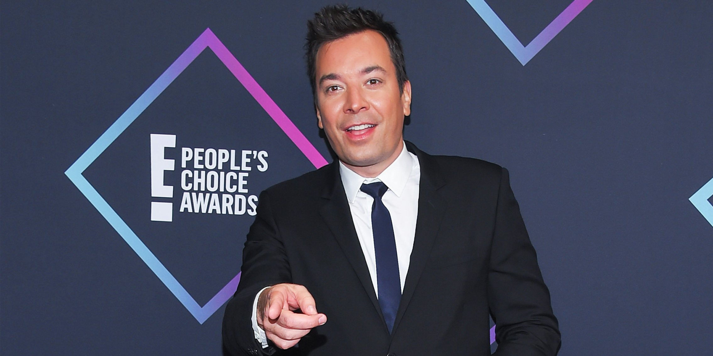 Jimmy Fallon in front of E People's Choice Awards on gray background