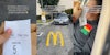 McDonald's worker holding mobile order outside caption 