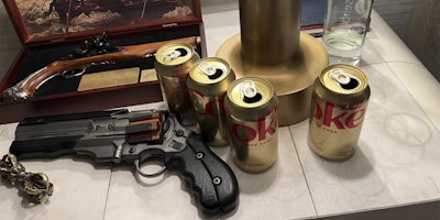 elon musk bedside table with empty diet coke cans, prop guns, and a dorje