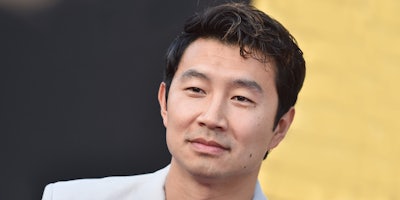 Simu Liu in front of gray and yellow background
