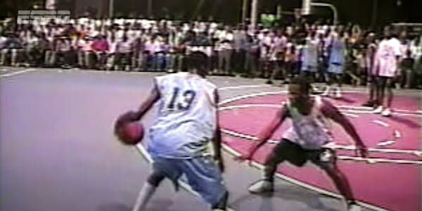 A screenshot from the 2022 ESPN documentary "The Greatest Mixtape Ever" showing two basketball players facing off on a street court as a large crowd watches.