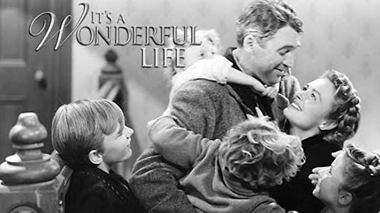 George Bailey embraces his wife while his children hug him beneath the title "It's A Wonderful Life."