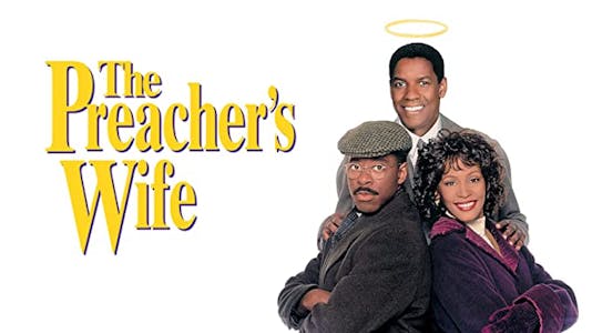 Denzel Washington with a halo over his head standing above Courtney B. Vance and Whitney Houston who are standing back to back in winter garb beside the title "The Preacher's Wife" in yellow lettering.