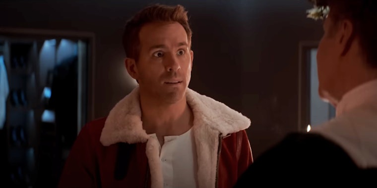 best streaming christmas movies - A shocked Ryan Reynolds wearing a winter coat looks at Will Ferrell who has his back to the camera.