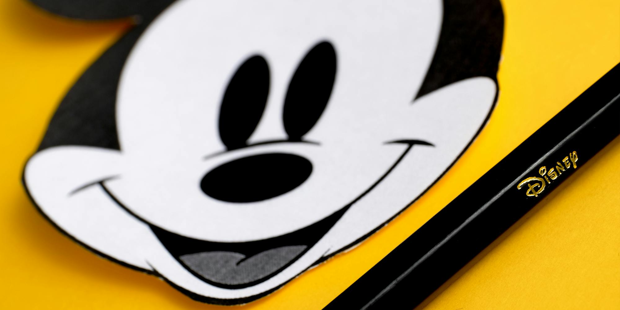 Mickey Mouse cutout drawing on yellow background with Disney pencil
