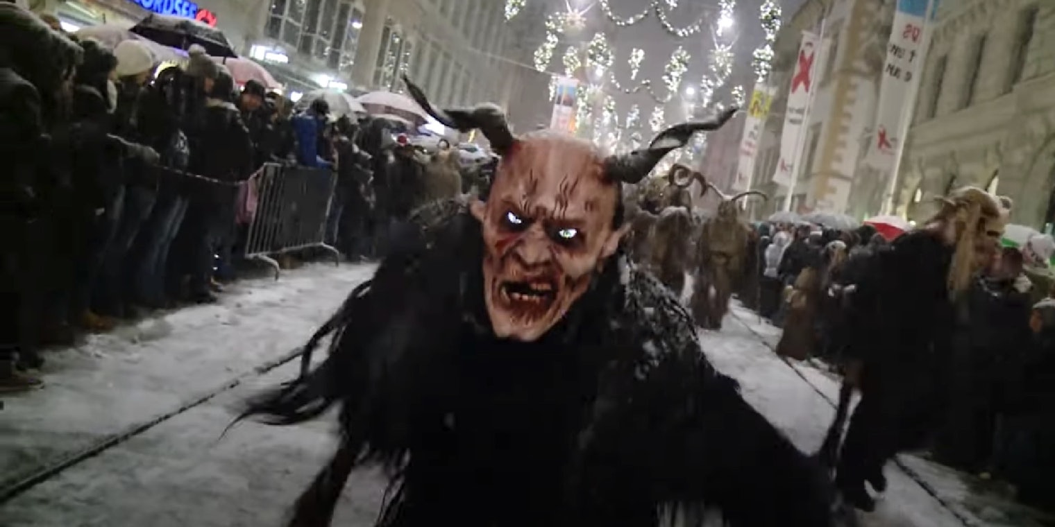An individual wearing a costume resembling the mythical goat creature known as Krampus
