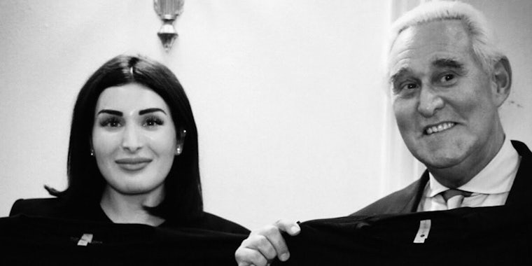 Laura Loomer and Roger Stone holding shirts black and white