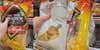 hand on tortilla chip bag at store (l) hand on tortilla chip bag at store (c) hand on tortilla chip bag turned to side at store (r)