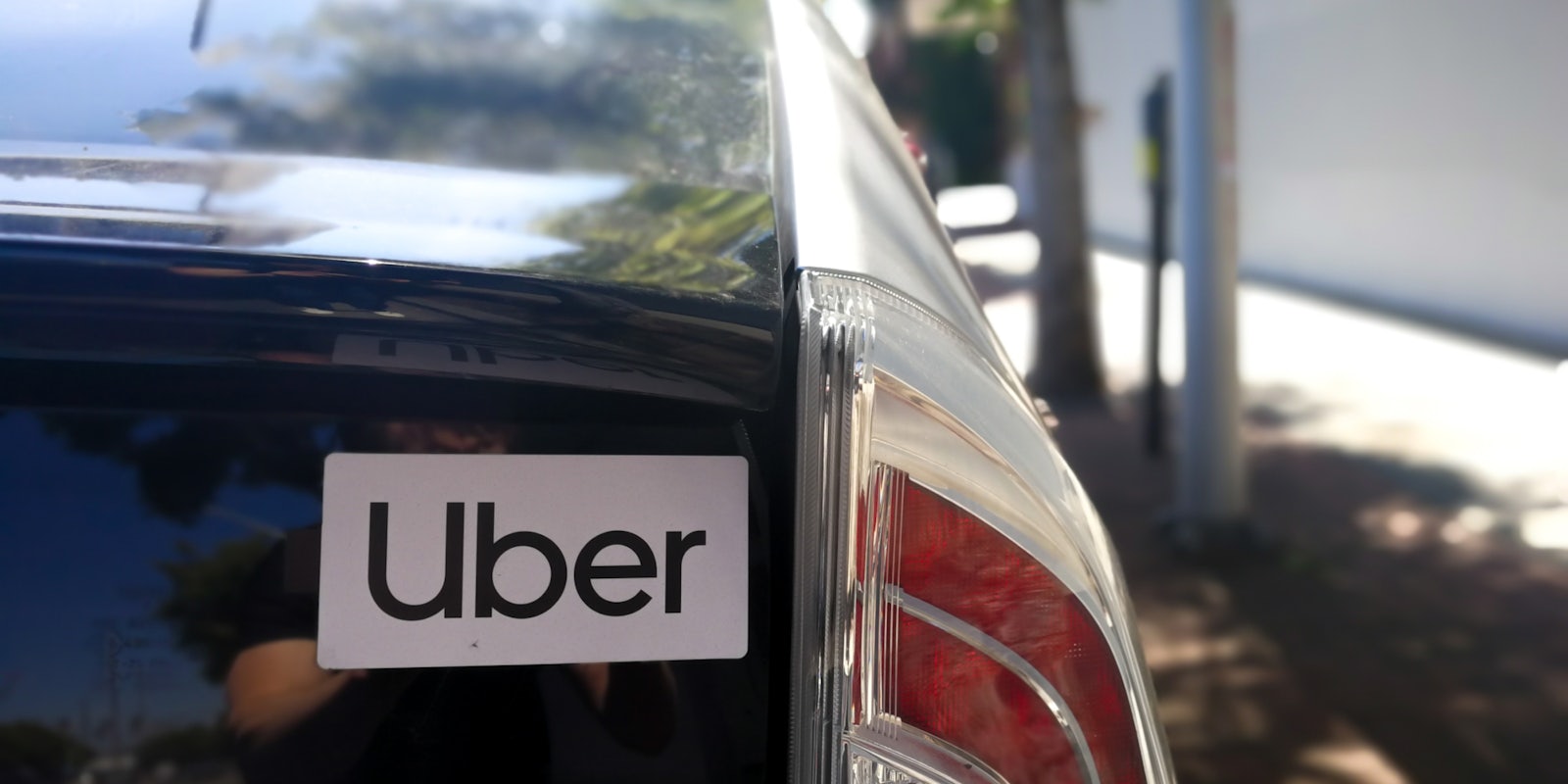 uber sticker on back of car