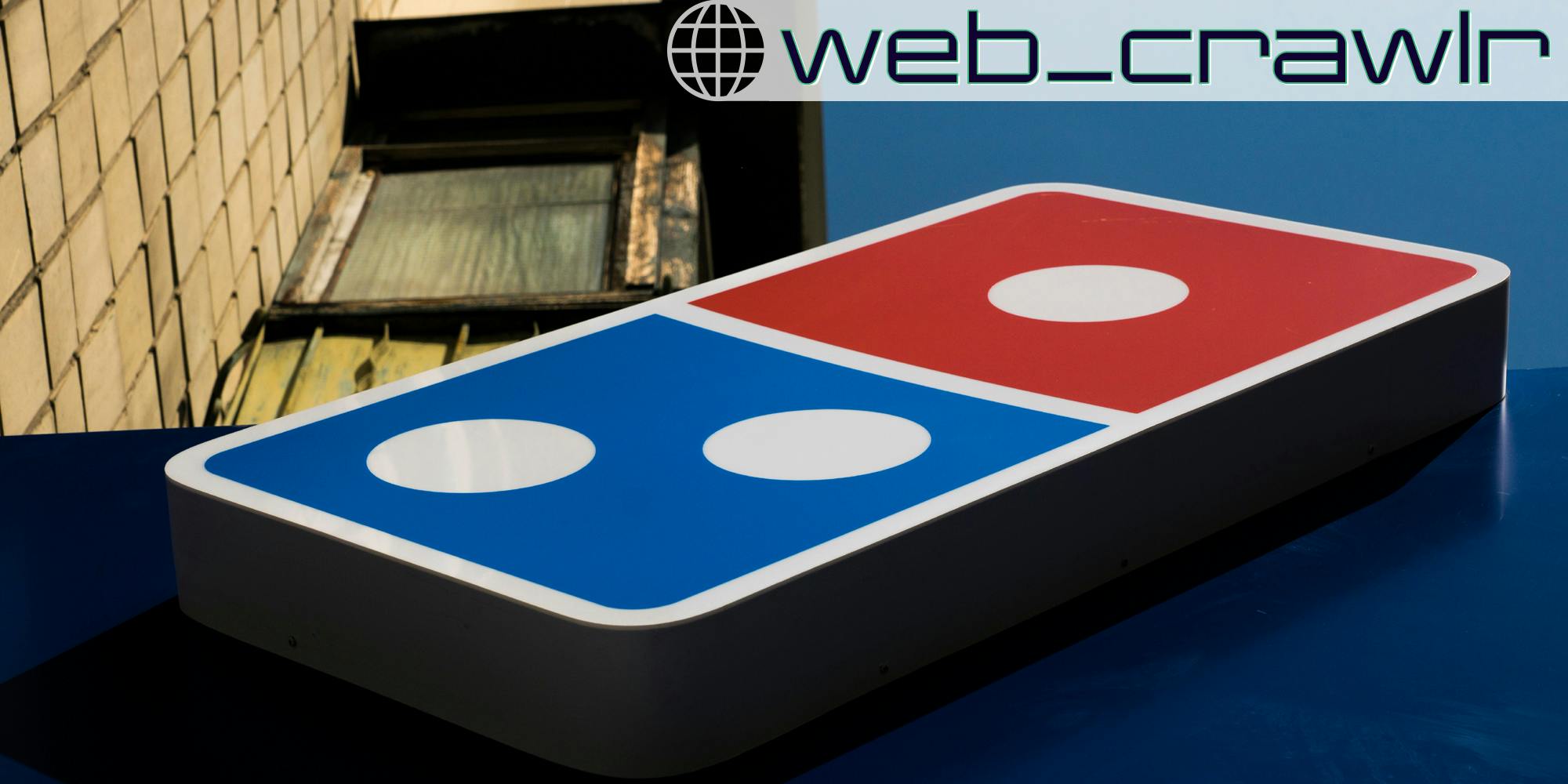A Domino's pizza sign. The Daily Dot newsletter web_crawlr logo is in the top right corner.