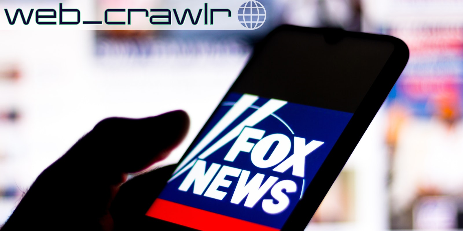 A phone with the Fox News logo on it. The Daily Dot newsletter web_crawlr logo is in the top left corner.