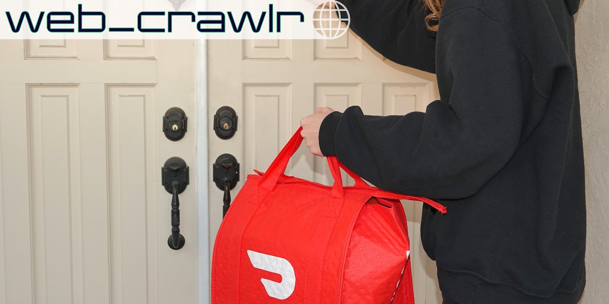 A person holding a bag with the DoorDash logo on it. The Daily Dot newsletter web_crawlr logo is in the top left corner.
