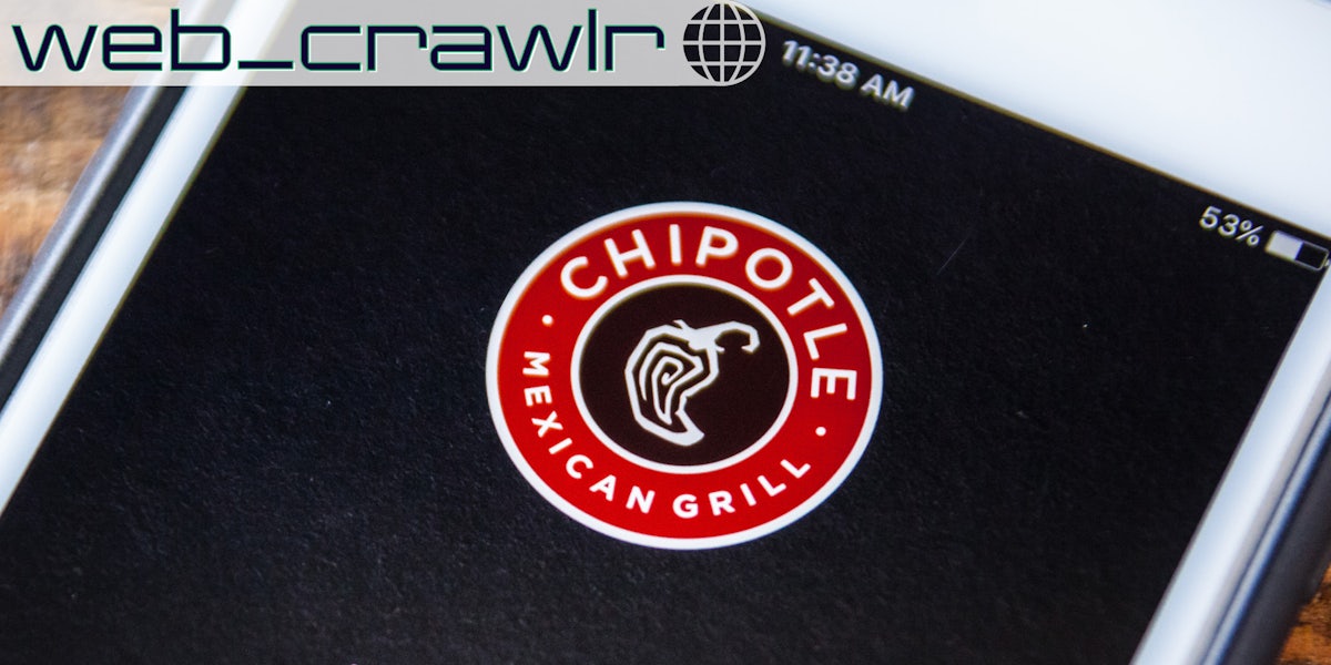 A phone showing the Chipotle logo. The Daily Dot newsletter web_crawlr logo is in the top left corner.