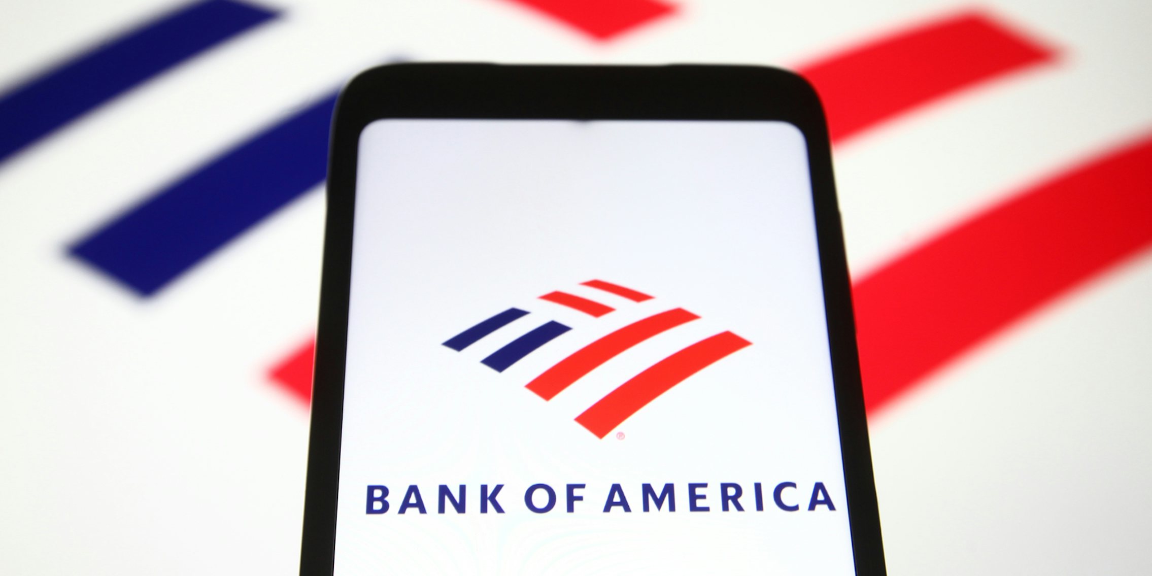 Bank of America on phone in front of Bank of America logo on white background