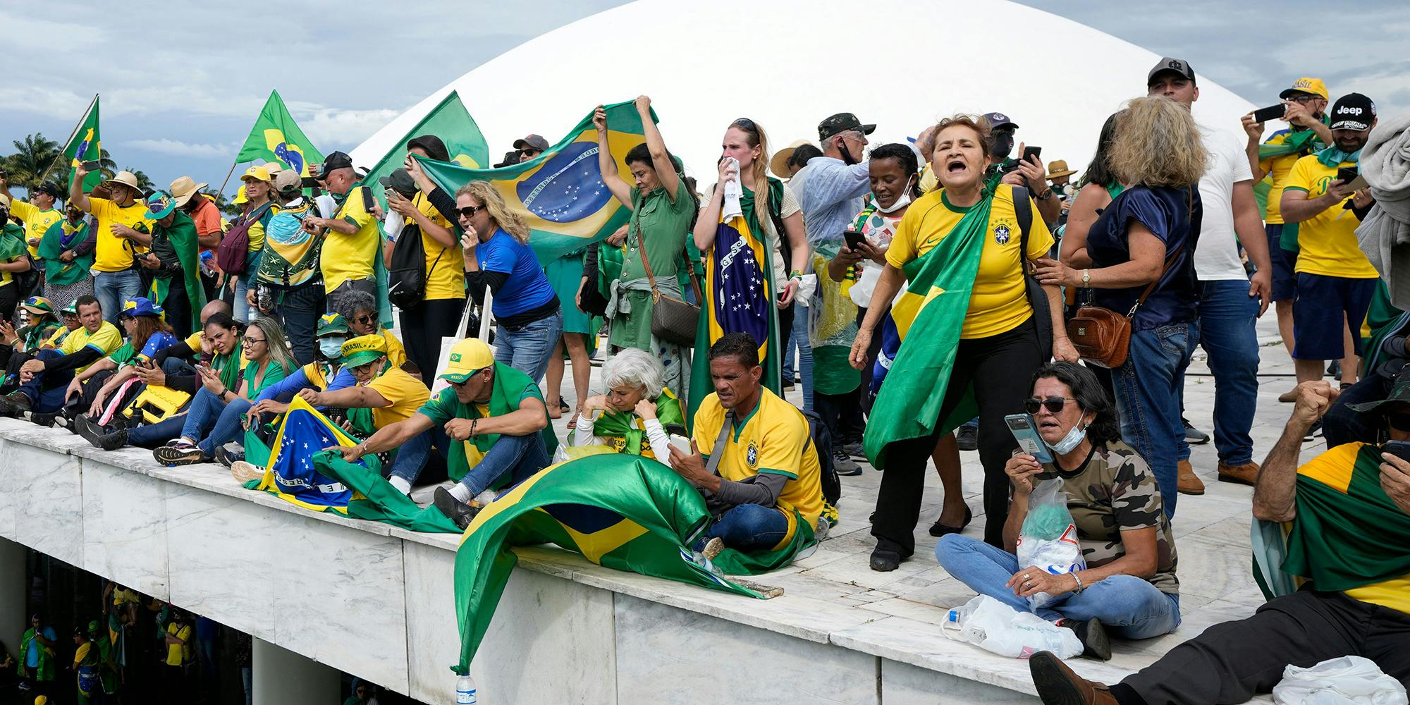 Protesters, supporters of Brazil's former President Jair Bolsonaro, stand on the roof of the National Congress building after they stormed it, in Brasilia, Brazil