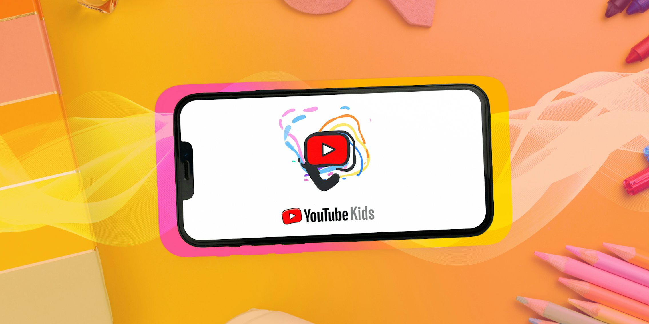 YouTube Kids on phone on table with children's craft supplies with yellow to pink diagonal gradient overlay Passionfruit Remix