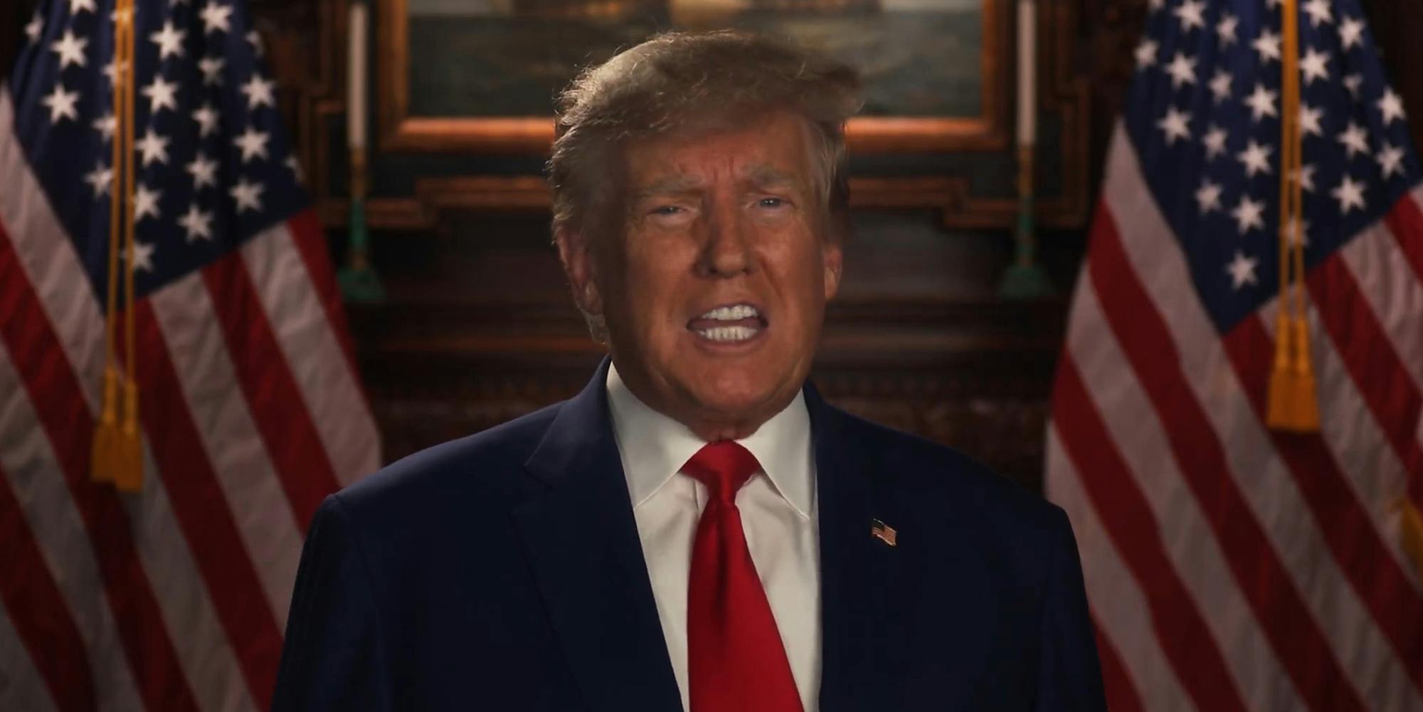 Donald Trump speaking in front of wooden framed painting and American flags