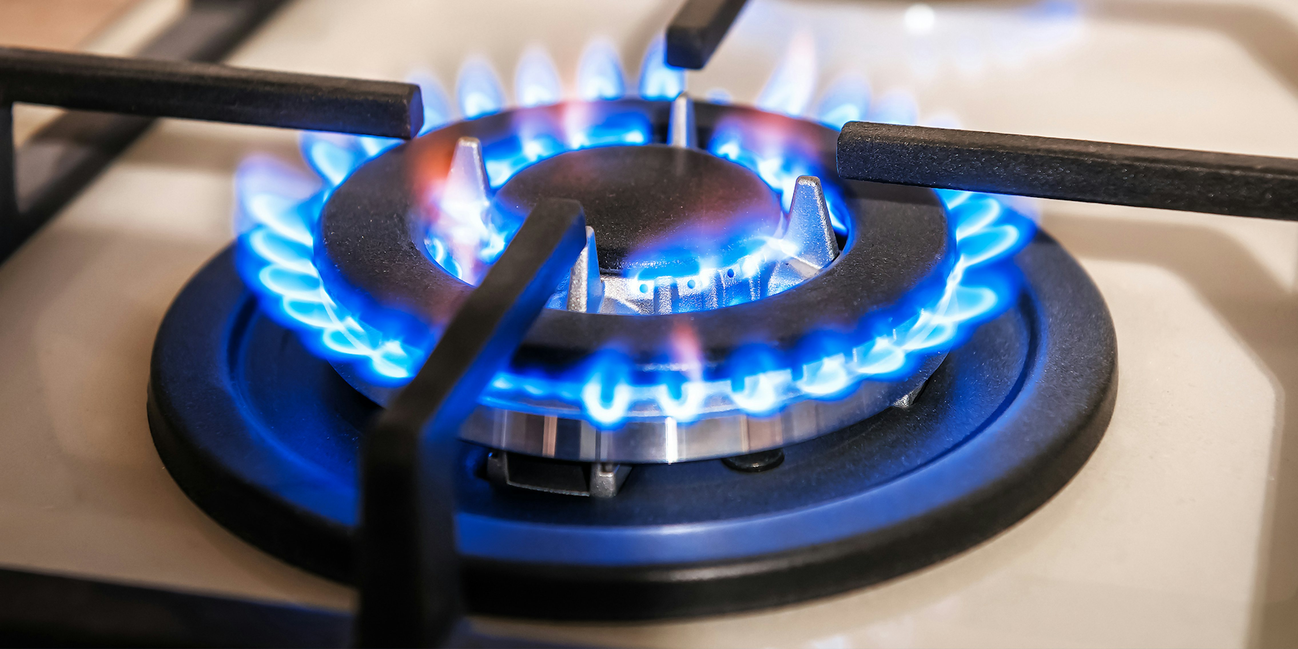 gas stovetop with blue flames