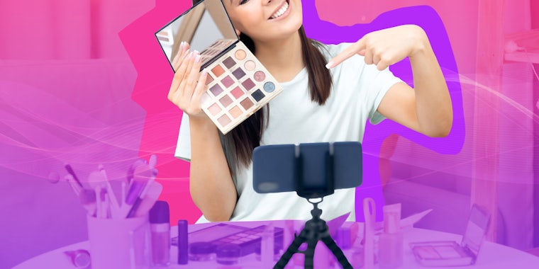 influencer recording on phone holding makeup in front of pink to purple vertical gradient background Passionfruit Remix