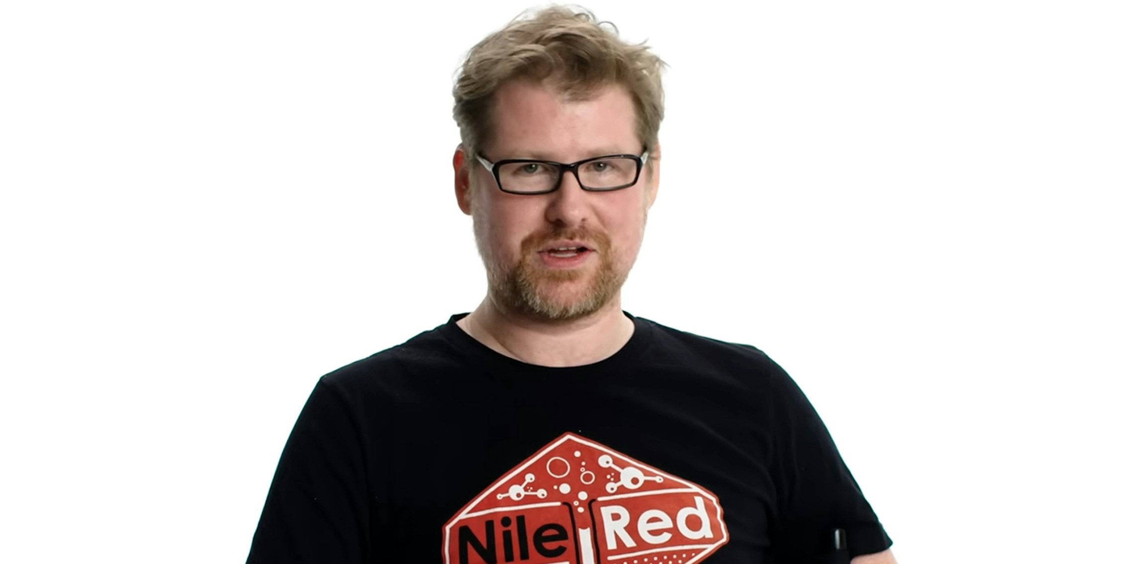 Justin Roiland speaking in front of white background