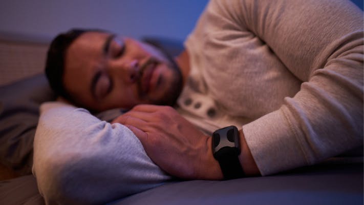 Man sleeping while wearing Apollo Neuro wearable