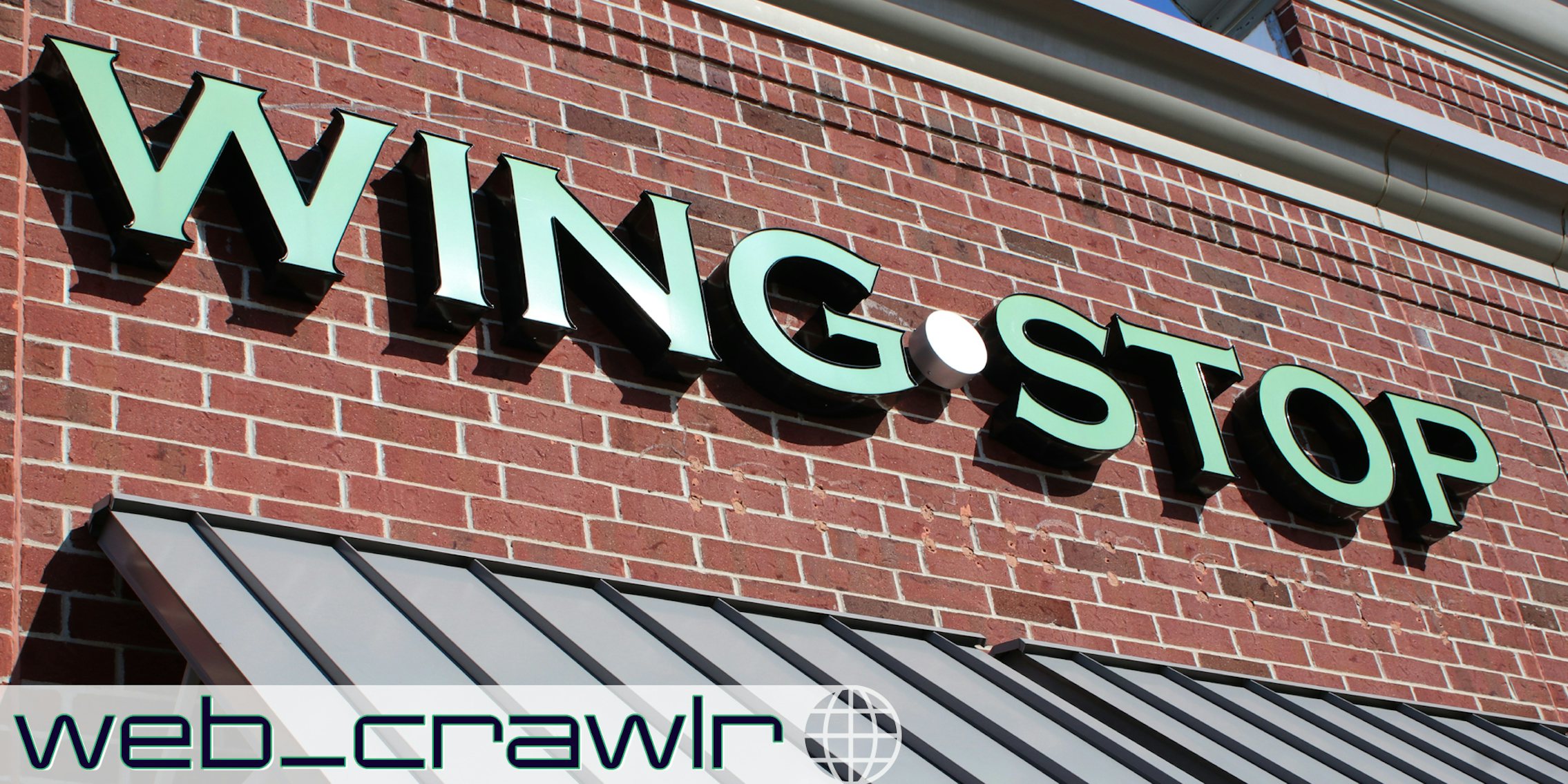 A Wing Stop sign. The Daily Dot newsletter web_crawlr logo is in the bottom left corner.