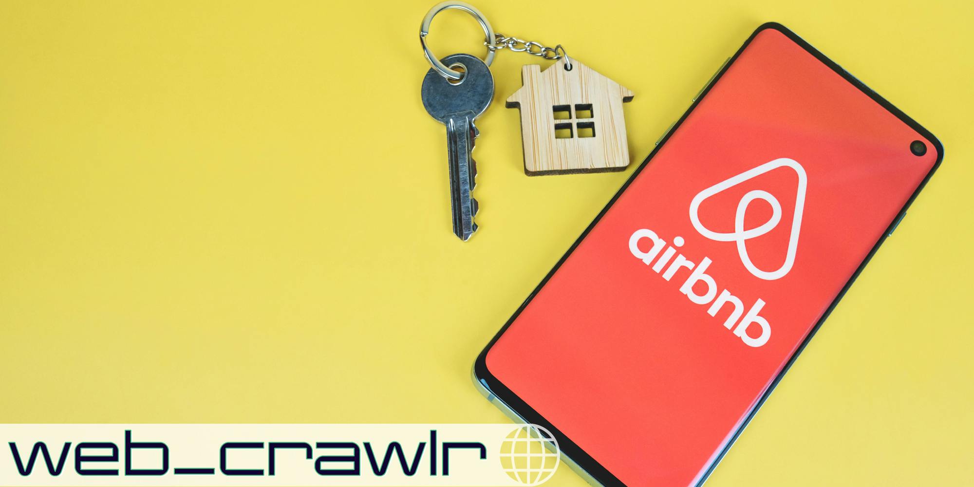 A phone with the Airbnb logo on it next to a set of keys. The Daily Dot newsletter web_crawlr logo is in the bottom left corner.