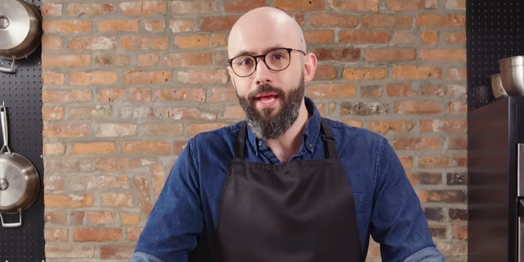 Binging with Babish aka Andrew Rea speaking in front of brick wall