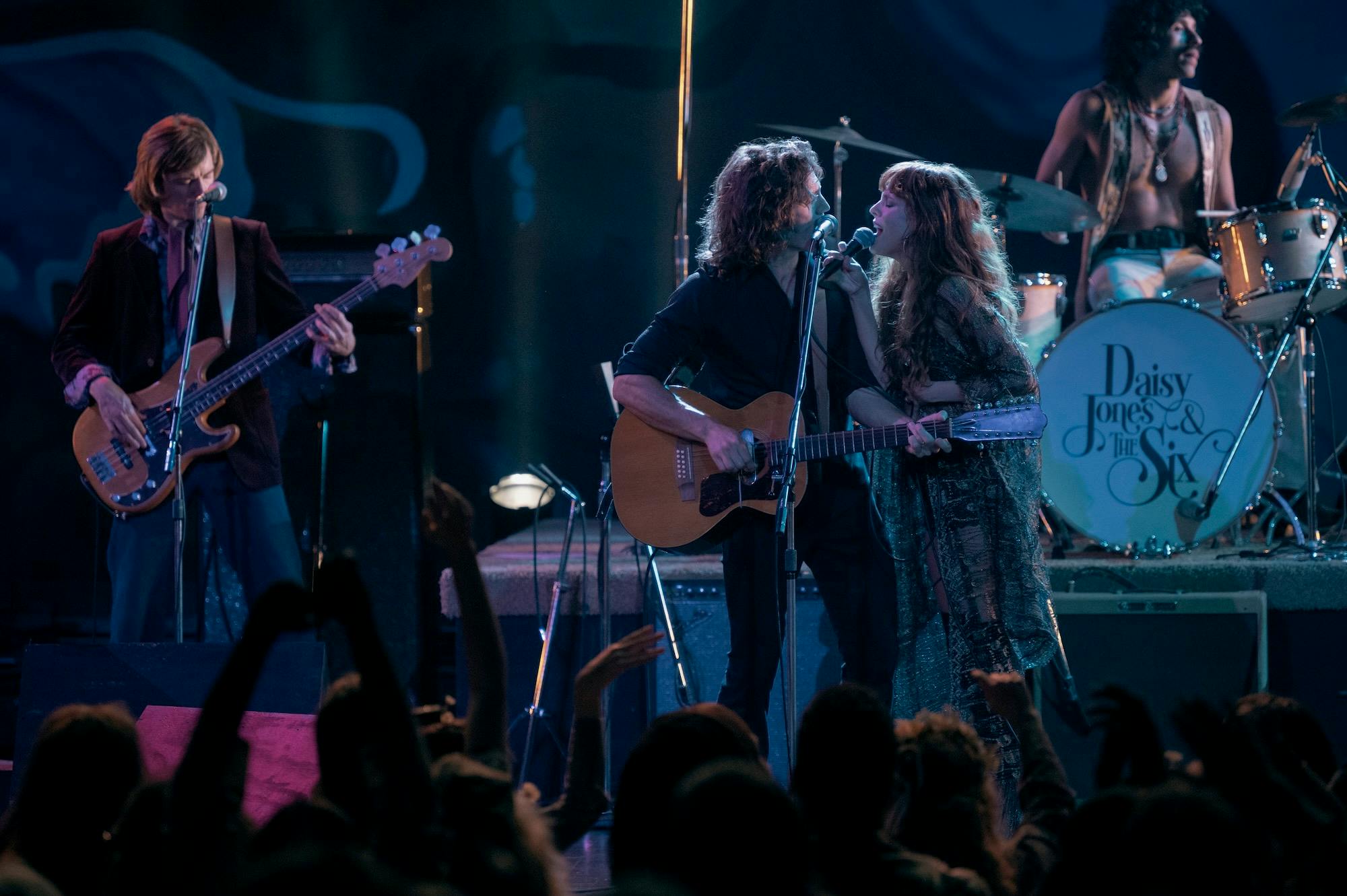 members of daisy jones & the six perform during a concert