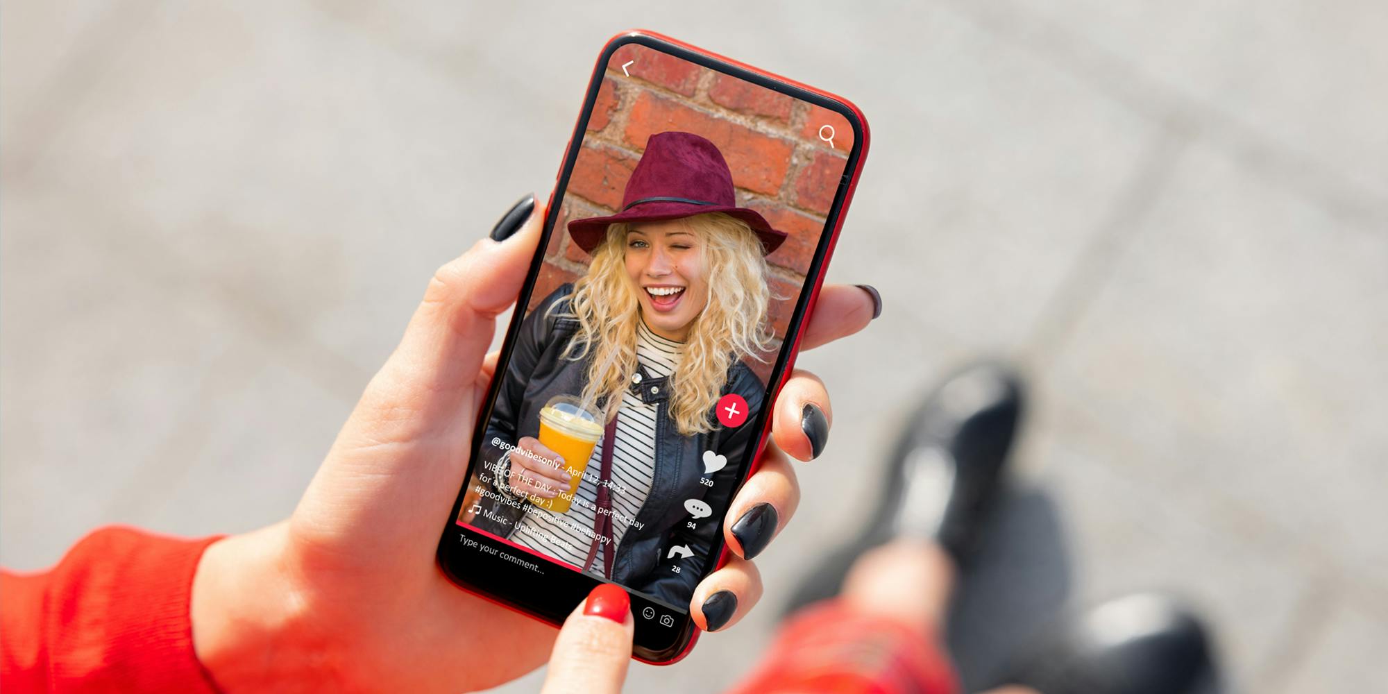 woman walking on sidewalk holding phone with TikTok app open