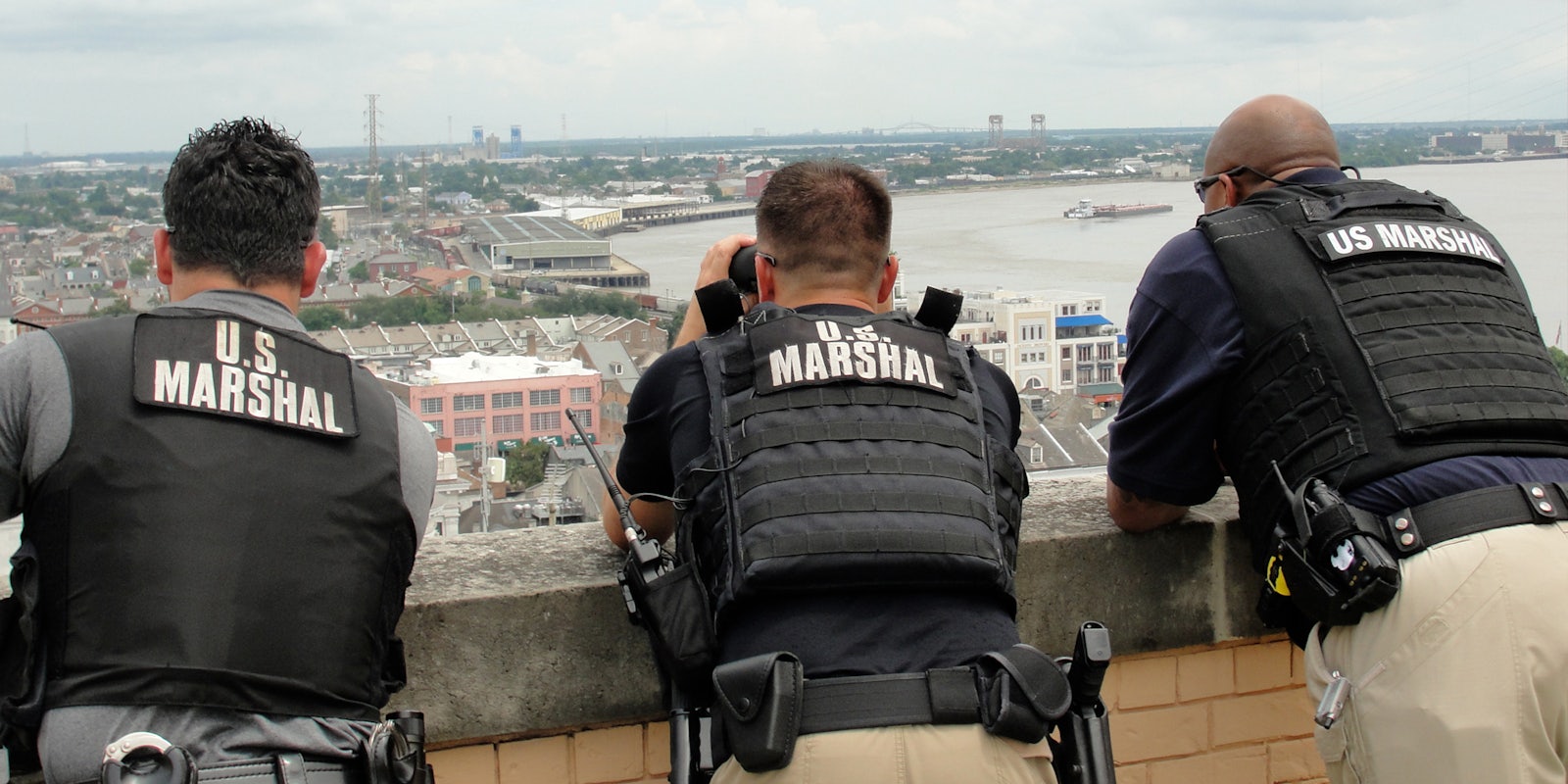 U.S. Marshals standing on roof