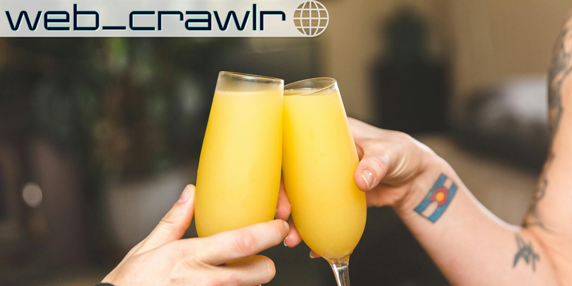 Two glasses of mimosa being tapped together. The Daily Dot newsletter web_crawlr logo is in the top left corner.