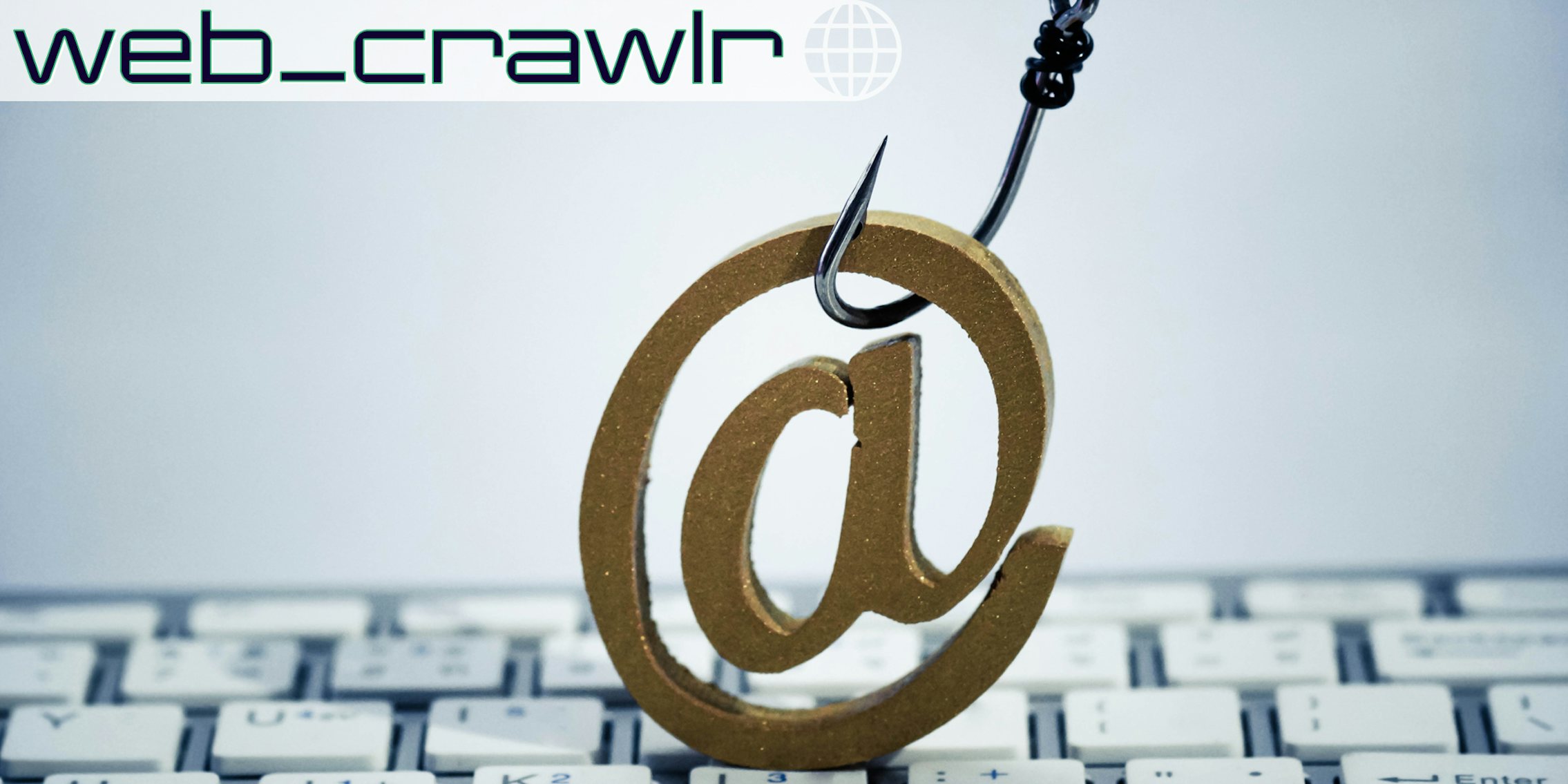 A fish hook with email sign on computer keyboard / Email phishing attack concept. The Daily Dot newsletter web_crawlr logo is in the top left corner.