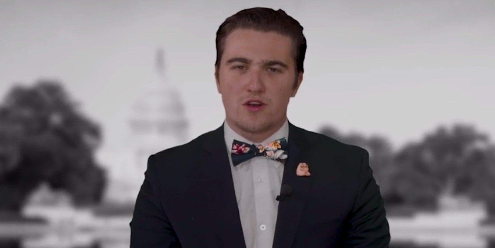 Dalton Clodfelter speaking in front of blurred greyscale background