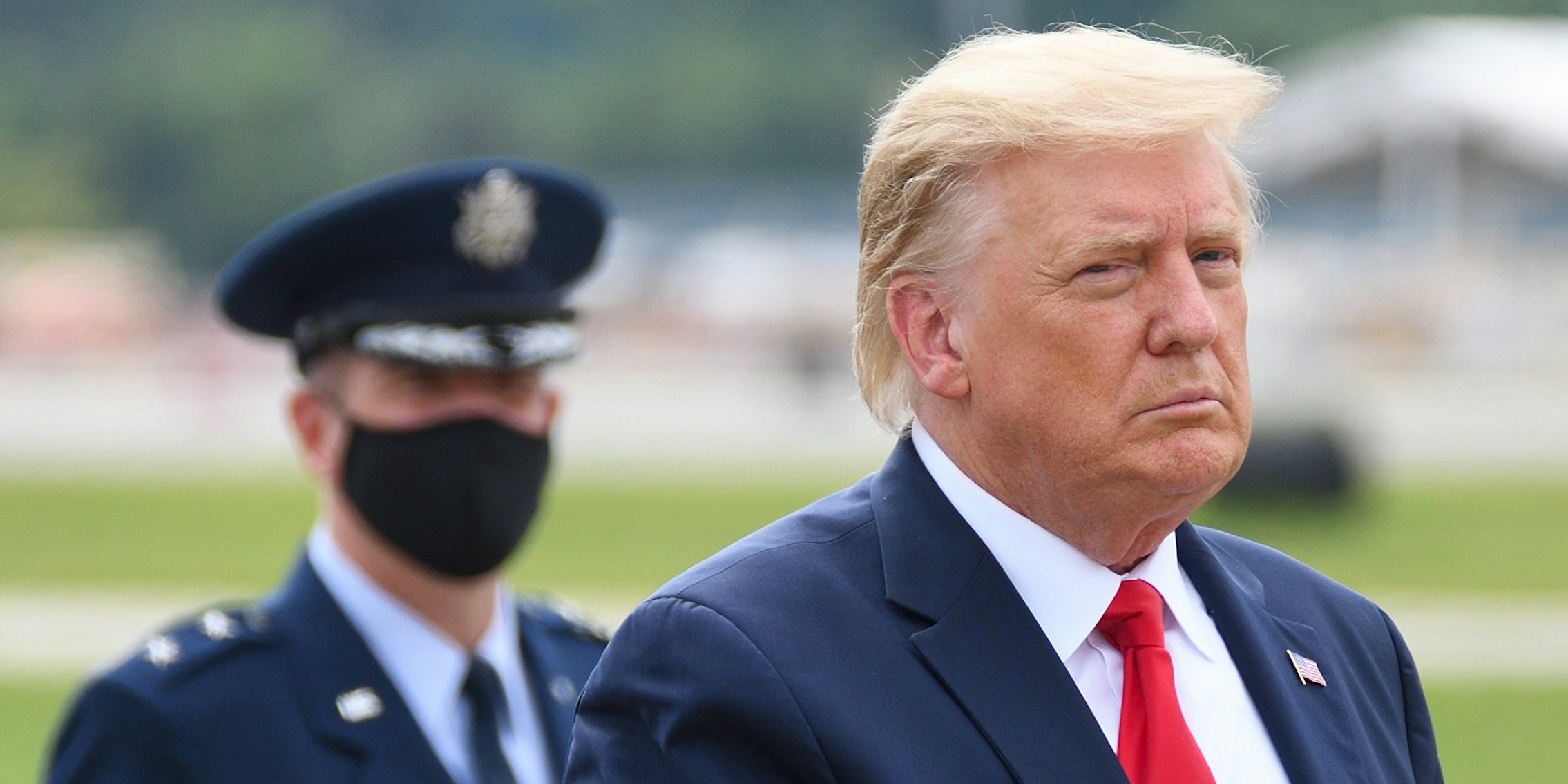President Donald Trump outside with Air Force Major General John P. Healy in the background